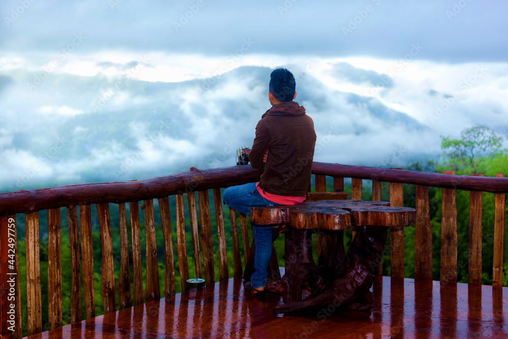 the man sitting on the stairs at view point in the morning