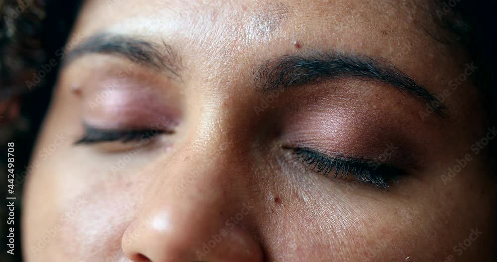 Hopeful woman closing eyes in contemplation and opening eye to sky with HOPE Hopeful woman closing eyes in contemplation and opening eye to sky with HOPE