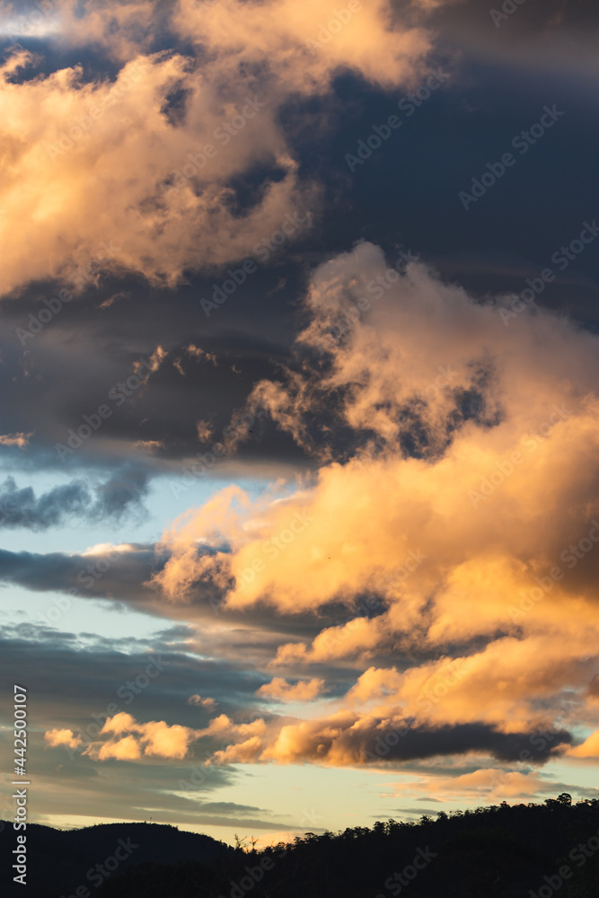 sunset sky with pink and orange clouds over the mountains