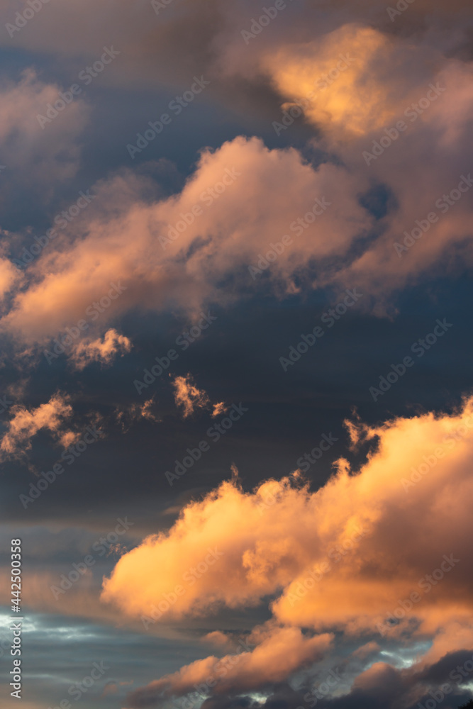 sunset sky with pink and orange clouds over the mountains