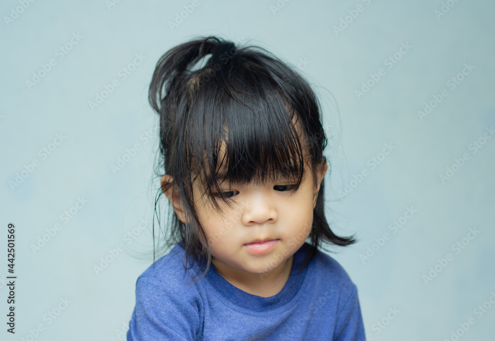 A headshot portrait of a cheerful baby Asian woman, a cute toddler little girl with adorable bangs hair, a child wearing a blue sweater smiling and don't looking to the camera. A headshot portrait of a cheerful baby Asian woman, a cute toddler little girl with adorable bangs hair, a child wearing a blue sweater smiling and don't looking to the camera.