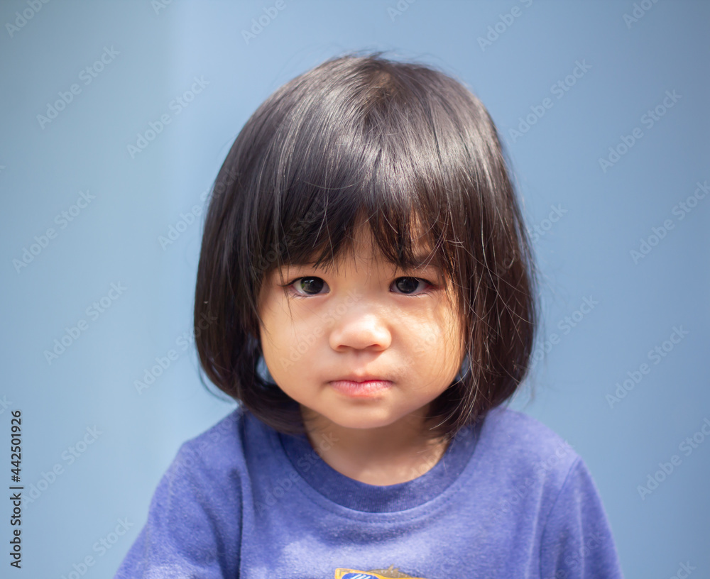 A headshot portrait of a cheerful baby Asian woman, a cute toddler little girl with adorable bangs hair, a child wearing a blue sweater smiling and looking to the camera. A headshot portrait of a cheerful baby Asian woman, a cute toddler little girl with adorable bangs hair, a child wearing a blue sweater smiling and looking to the camera.