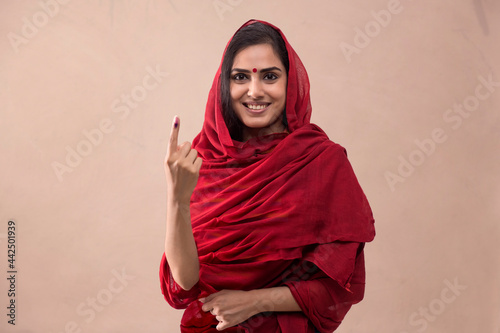 Tableau sur toile Portrait of a woman standing with voters mark.