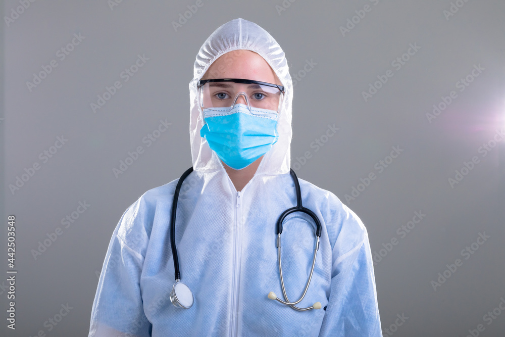 Caucasian female doctor wearing ppe suit, isolated on grey background Caucasian female doctor wearing ppe suit, isolated on grey background