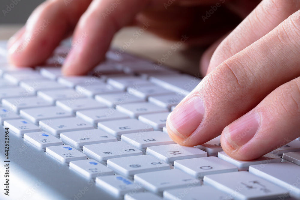 Close up of caucasian businessman typing on keyboard, isolated on grey background Close up of caucasian businessman typing on keyboard, isolated on grey background