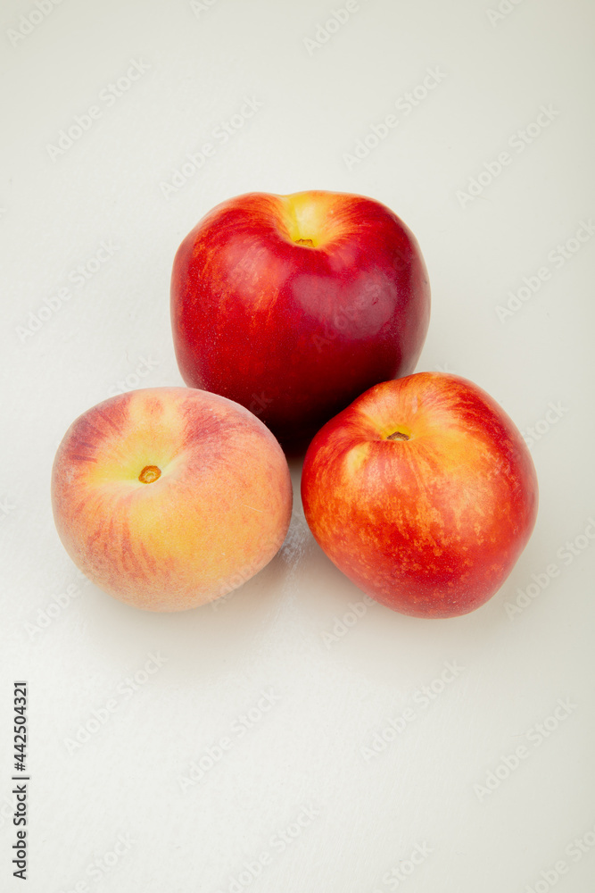 side view of fresh ripe peach and nectarine fruits isolated on white background side view of fresh ripe peach and nectarine fruits isolated on white background