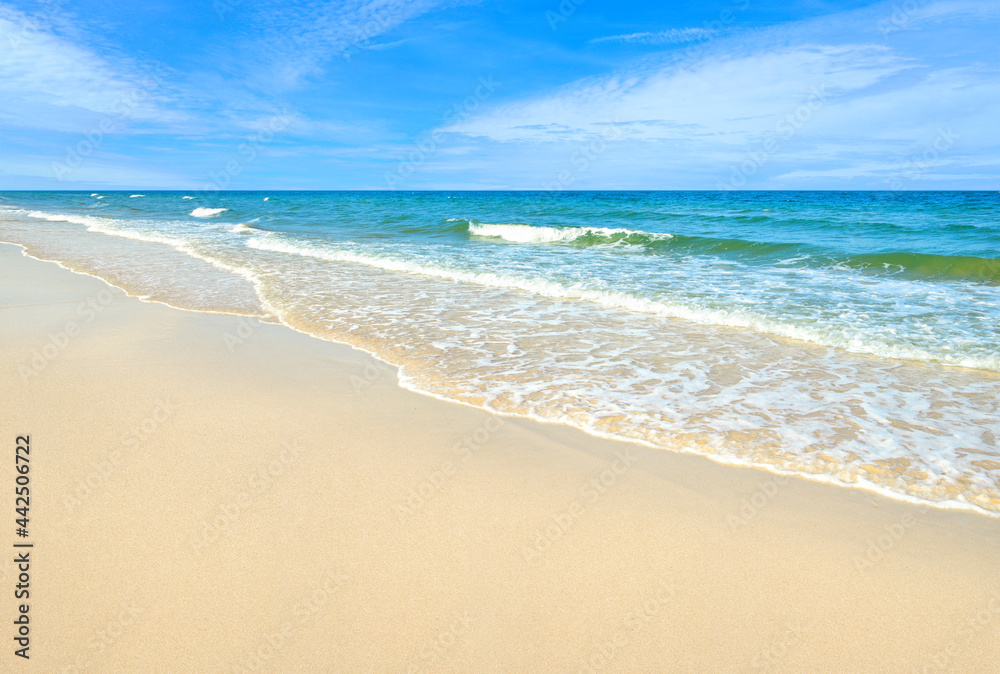 Summer sand beach with ocean waves and blue sky background. Summer sand beach with ocean waves and blue sky background.
