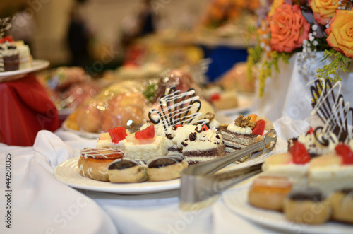Wallpaper Mural Sweet snacks various small cakes with butter cream and chocolate on a plate on a banquet table in a restaurant Torontodigital.ca