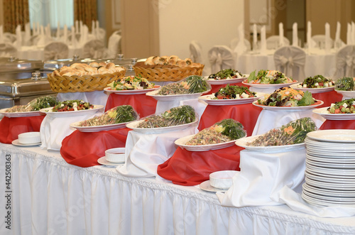 Wallpaper Mural Catering a lot of salads from vegetables and meat on a white and red tablecloth in a large banquet hall Torontodigital.ca