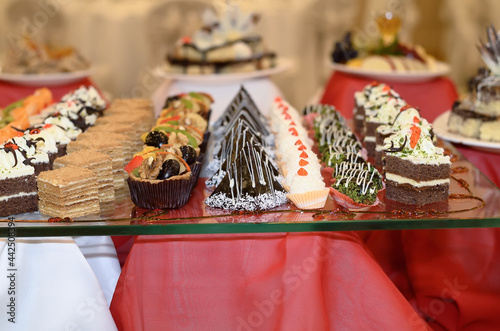 Wallpaper Mural Catering a lot of sweet snacks from small cakes with cream and chocolate cream and fruit on the glass in the banquet hall Torontodigital.ca
