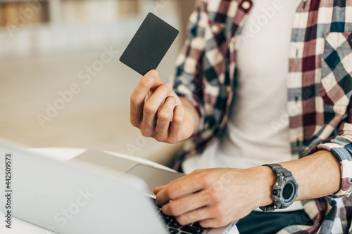 man holding credit card and using laptop, concept of online shopping, online payment © Shopping King Louie