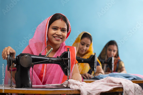A group of rural women working on sewing machines. photo