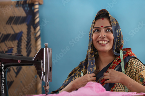 A woman sitting by the sewing machine.