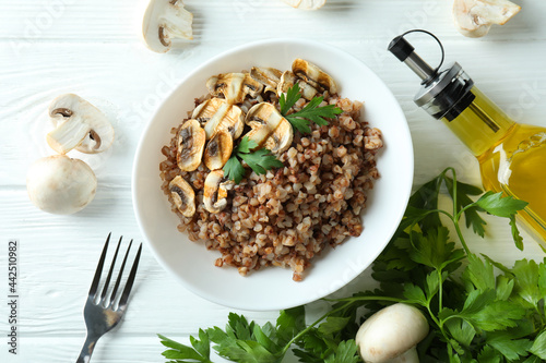 Concept of tasty eating with buckwheat on wooden table