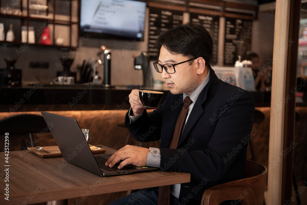 Businessman relax by drinking coffee while working in a coffee shop