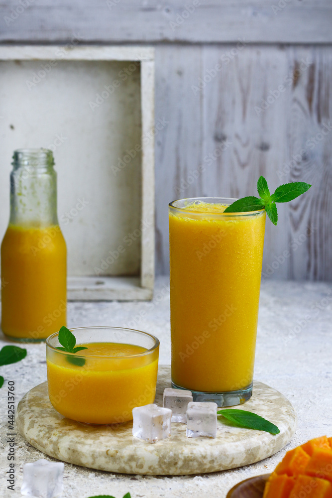 Fototapeta premium Mango Juice or jus mangga on white background. Fresh healthy during during summer holiday.