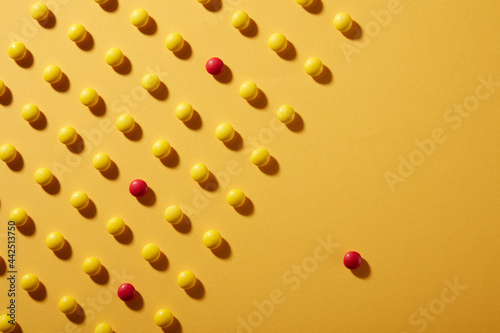 Yellow Chocolate candies on yellow Colored paper background