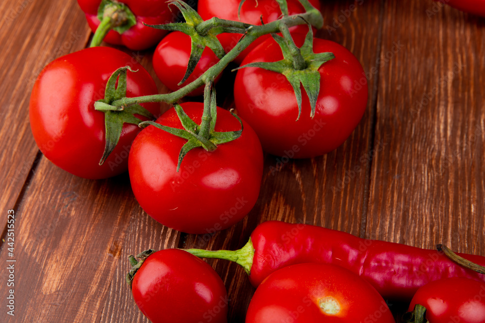 side view of fresh vegetables ripe tomatoes with red chili peppers on rustic wooden background side view of fresh vegetables ripe tomatoes with red chili peppers on rustic wooden background
