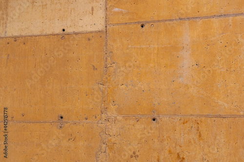 orange colored raw concrete wall. textured background.