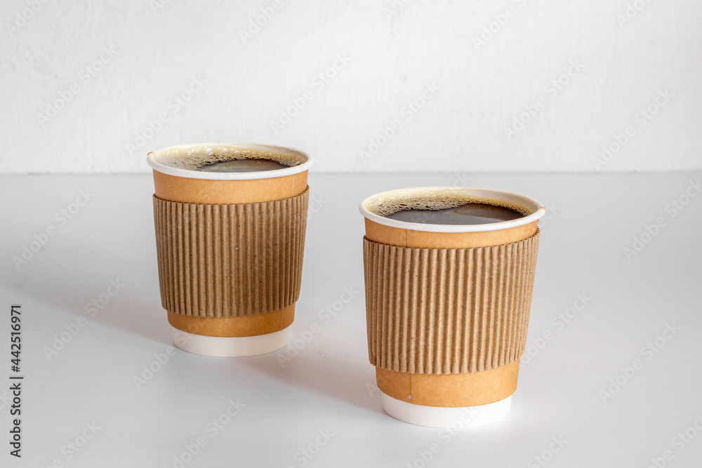 Take out coffee in paper cups on the table. Close up Take out coffee in paper cups on the table. Close up
