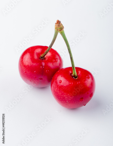 side view of red ripe cherry with water drops isolated on white background