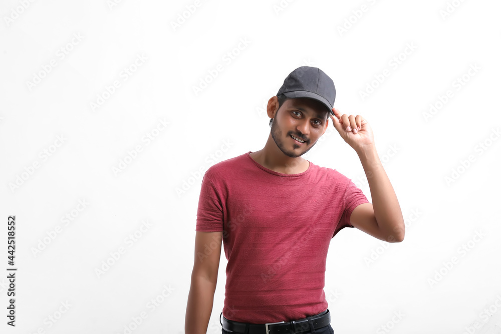 Young indian delivery boy showing expression over white background. Young indian delivery boy showing expression over white background.