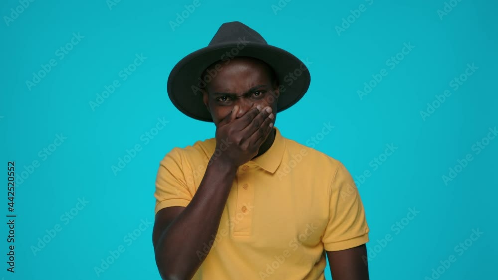 Displeased man covering nose because of bad smell Displeased man covering nose because of bad smell
