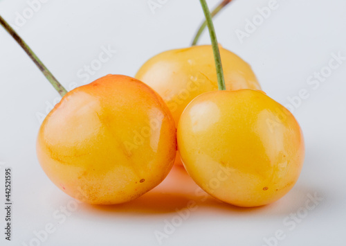 side view of yellow ripe cherry isolated on white background