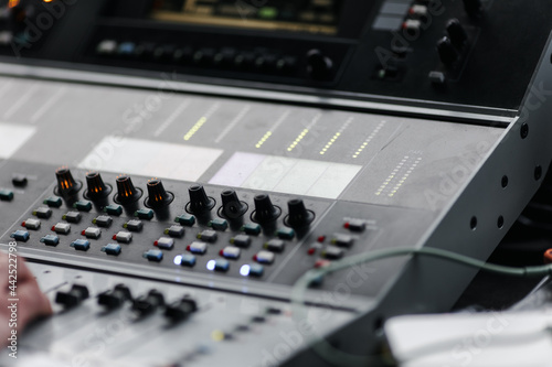 Sound mixer. Professional sound mixing console with backlight, buttons, faders and sliders.