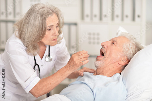 Wallpaper Mural Senior man portrait in hospital with caring doctor Torontodigital.ca