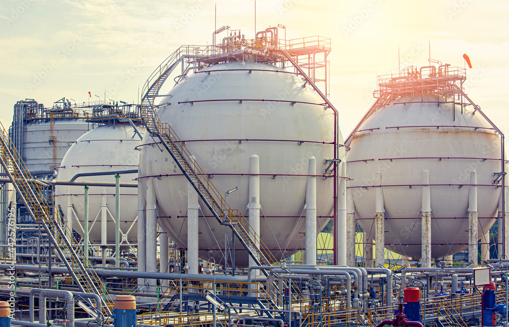 White spherical propane tanks containing fuel gas pipeline White spherical propane tanks containing fuel gas pipeline