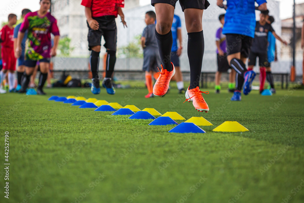 Soccer ball tactics on grass field with barrier for training children jump skill Soccer ball tactics on grass field with barrier for training children jump skill