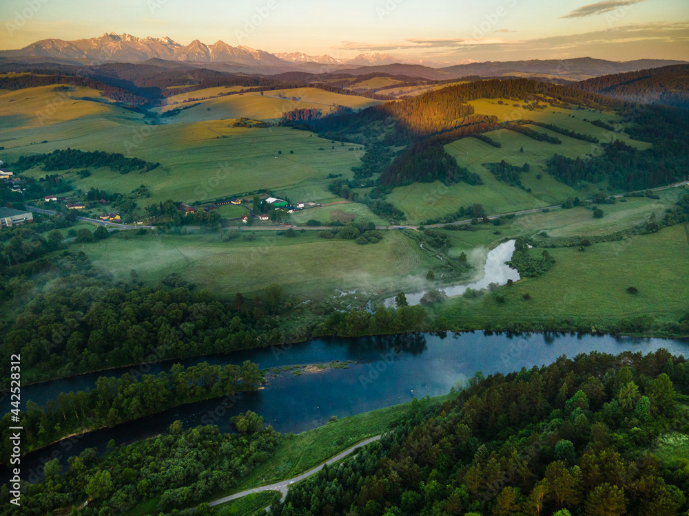 Fototapeta premium Sunrise in Pieniny Park in Poland. High Tatra Mountains and Dunajec River