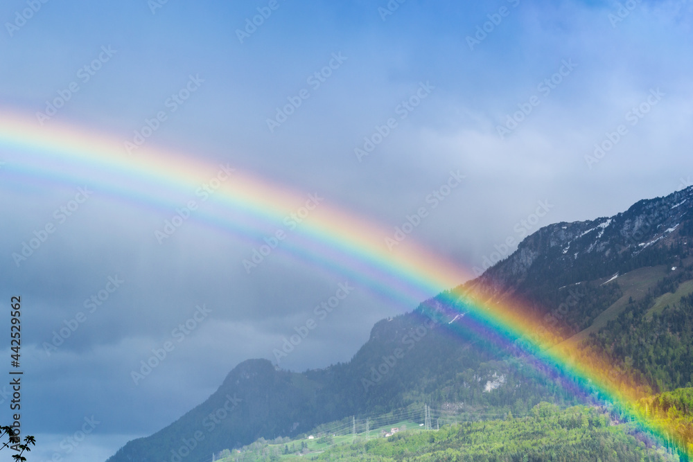 Rainbow in the sky over the mountains. Switzerland Rainbow in the sky over the mountains. Switzerland