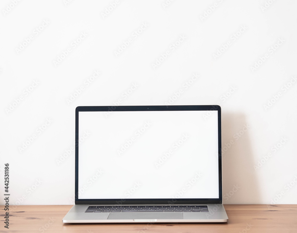 Home office wood desk with open laptop with white blank screen for text. Home office wood desk with open laptop with white blank screen for text.