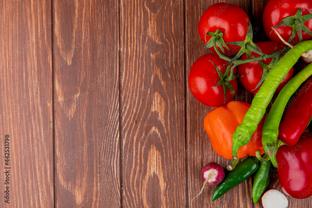 top view of fresh vegetables ripe tomatoes green chili peppers colorful bell peppers and radish on wooden rustic background with copy space top view of fresh vegetables ripe tomatoes green chili peppers colorful bell peppers and radish on wooden rustic background with copy space