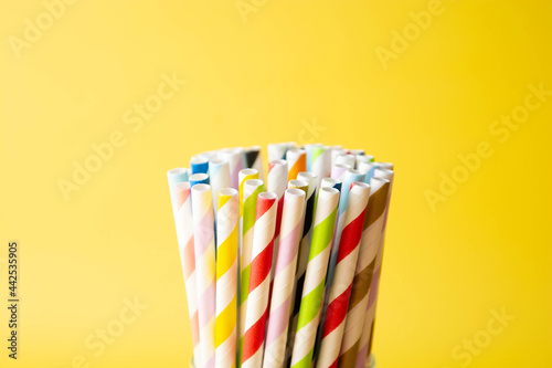 Biodegradable paper eco straws. Zero waste straws on yellow background. Copy space.