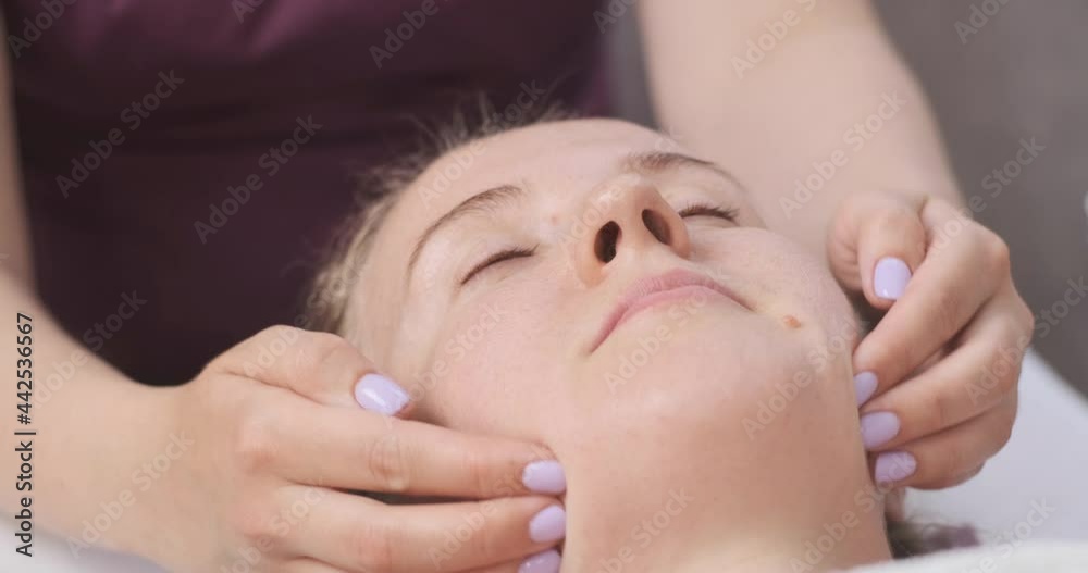 Girl receiving facial massage. Corrective facial massage. Facebook building. Close up. Girl receiving facial massage. Corrective facial massage. Facebook building. Close up.