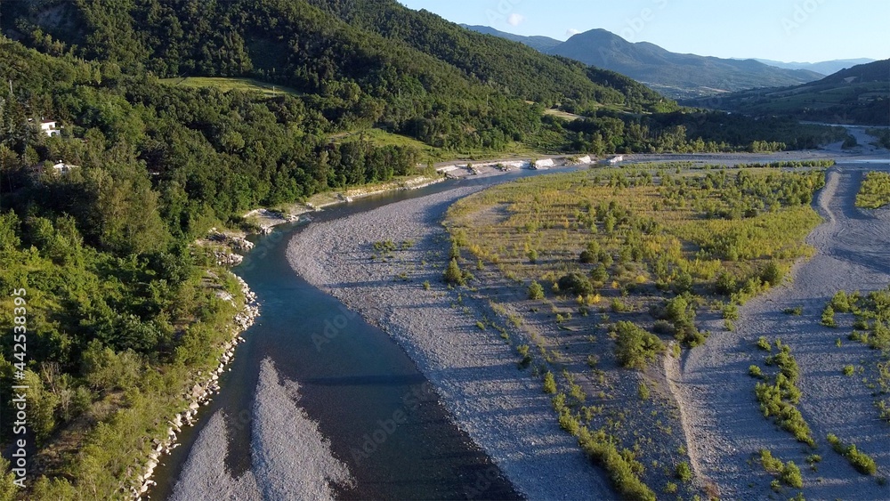 Italy, Bobbio , Piacenza , Val Trebbia - drought in the river - decrease in river water level caused by the melting of glaciers - the  Apennines countryside landscape with hills -Drone aerial view