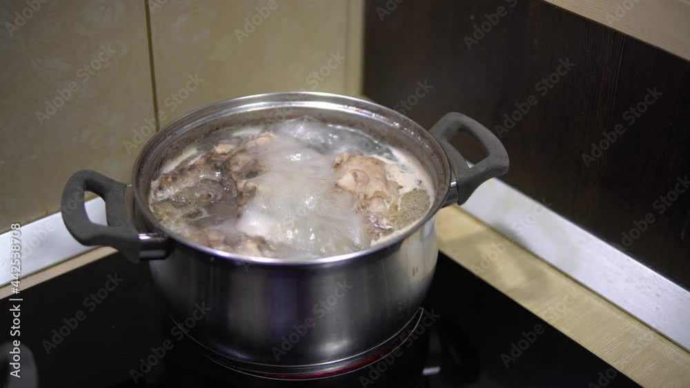Boiling meat broth in a saucepan on the stove. Home cooking Stock Video ...