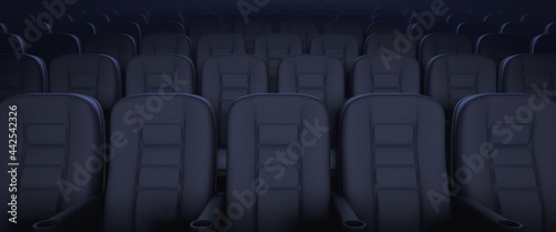 Rows of armchairs in an empty auditorium