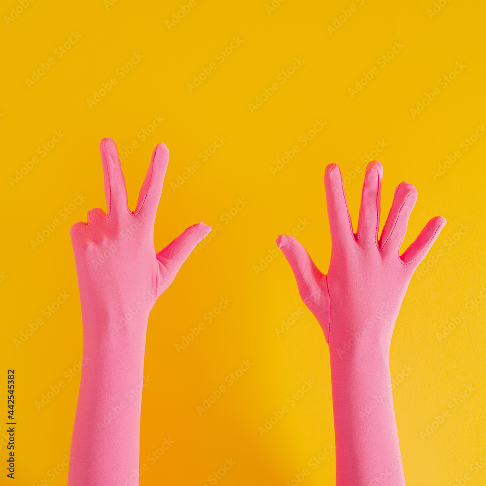 hands with pink glove and number eight on yellow sunny summer background. modern summer abstract art hands with pink glove and number eight on yellow sunny summer background. modern summer abstract art