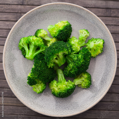 healthy food. steamed broccoli inflorescences in a bowl. top view