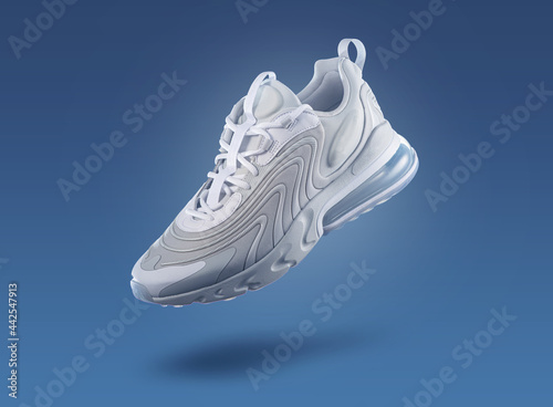 White sneaker on a blue gradient background, men's fashion, sport shoe, air, sneakers, lifestyle, concept, product photo, levitation concept  photo