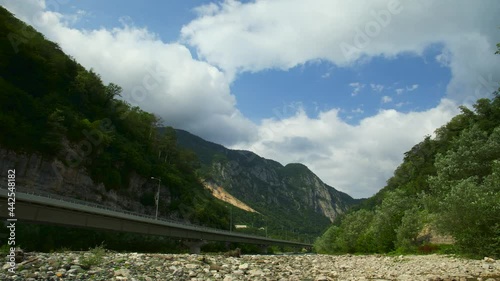 Wallpaper Mural Mountain valley filmed in time laps. The highway runs along the riverbed. High rocks around. Clouds float on high cliffs. Mountain landscape. Torontodigital.ca