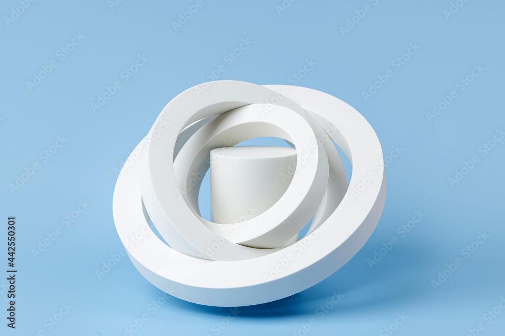 White podium to show cosmetic products with geometric forms on blue background. Background for branding and packaging presentation. Natural skincare beauty product concept. White podium to show cosmetic products with geometric forms on blue background. Background for branding and packaging presentation. Natural skincare beauty product concept.