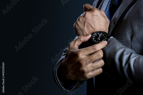 Businessman checking time on watch