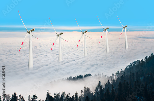 Wind turbines generating electricity over the mountains with cloudy sky