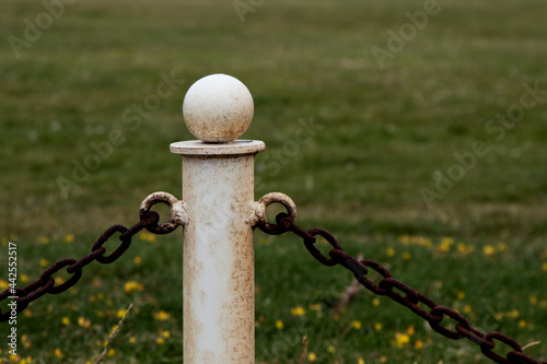 Old Metal Barrier Stanchion with Chain Fence in a Park