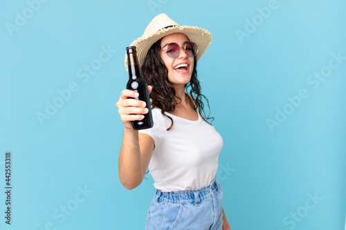 hispanic pretty traveler woman with a bottle of beer photo